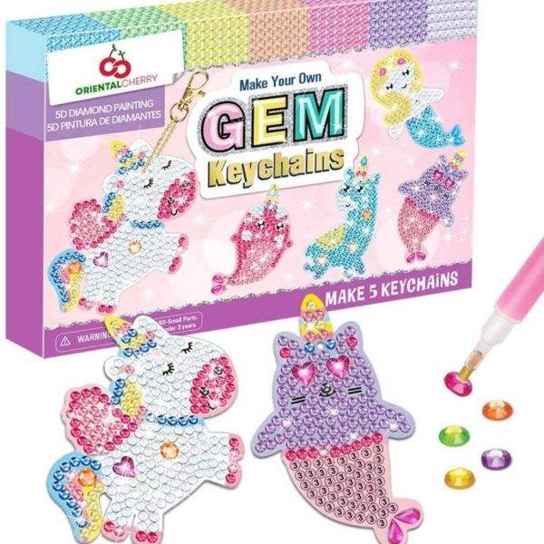 Sentence with product name: A make your own glamping jewelry kit labeled "make your own gem keychains" featuring colorful keychain designs with a diamond painting tool and colorful gems. the kit includes materials to create five animal-shaped keychains.