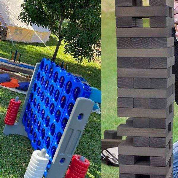 A split image featuring a giant XL Outdoor Games Addon connect four on the left, with blue and red discs in a blue rack, and a tall, wooden jenga tower on the right, set on grass.