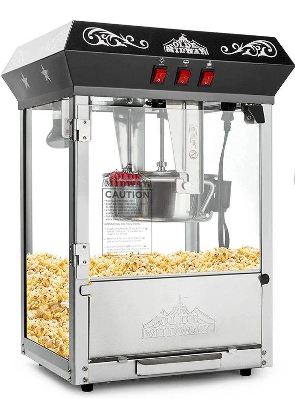 Commercial popcorn machine with a stainless steel base and clear glass panels, filled with freshly popped popcorn, perfect for an outdoor movie night, labeled "Olde Midway.