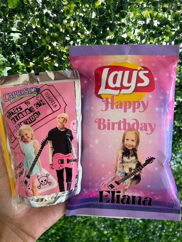 A hand holds two custom birthday snack packages: a Capri Sun juice pouch featuring nostalgic images labeled "mixtape", and a pink "292188731_1435129270244593_7973682324553567415_n" potato chip bag with a girl posing.