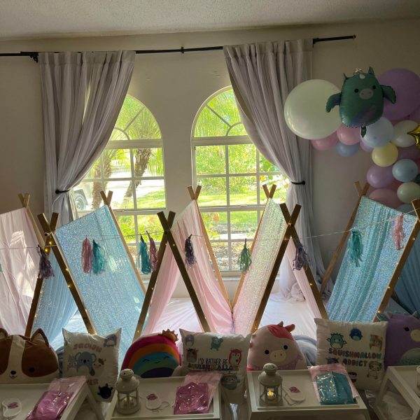 What makes our Balloon Burst company different than other companies is our bright, indoor sleepover setup featuring several mini teepees adorned with fairy lights, colorful balloons, and themed cushions. Each teepee has a Balloon Burst-themed room filled with colorful balloons.