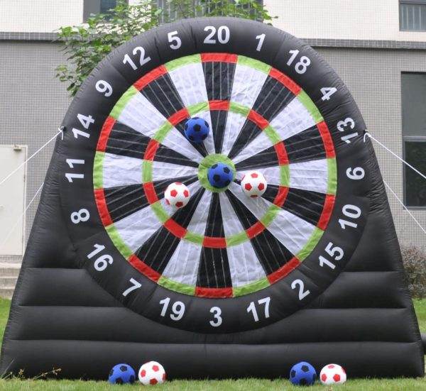 Inflatable soccer darts game featuring Velcro soccer balls stuck to the target areas, set up on a grassy outdoor area.

Product Name: Giant Outdoor Inflatable Soccer Darts Board