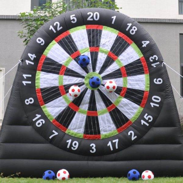 A Giant Outdoor Inflatable Soccer Darts Board for the ultimate party experience, featuring soccer balls and darts, placed on a grassy lawn with velcro soccer balls stuck on various scoring areas.