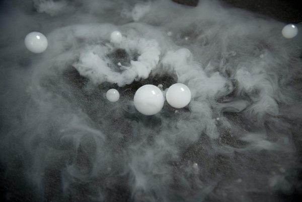 A group of Frogger F4 Bubble Fogger Rental eggs floating in a cloud of smoke at a party.
