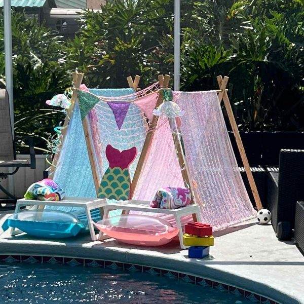 A mermaid tent set up beside a pool for a fun party.