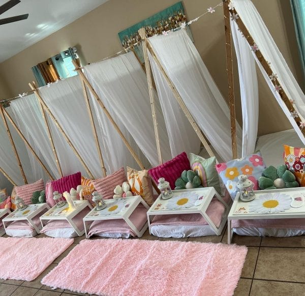 Indoor Slumber Party Tampa Fl setup with teepees, fur rugs, and decorated trays arranged on the floor.