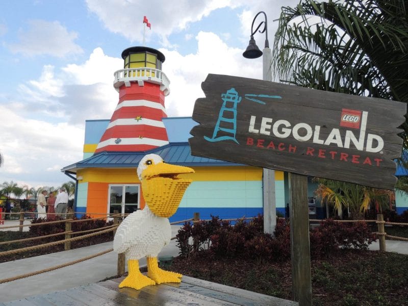 Unfortunately, a Lego model of a duck is located in front of the colorful Legoland beach retreat entrance, featuring a striped lighthouse.