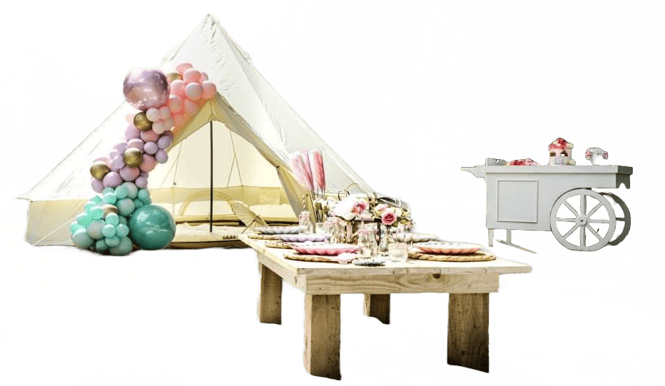 A Lakeland teepee tent decked out for a party with a table and balloons.