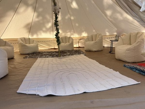 A white tent with chairs and a rug in the middle, perfect for a party in Lakeland.