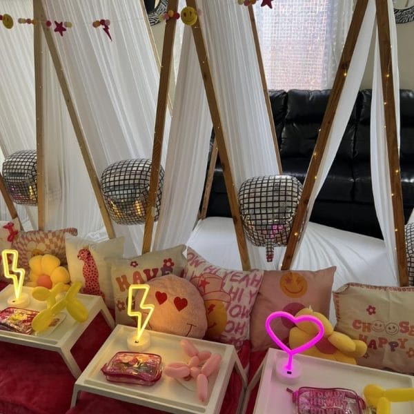 A party room filled with pink and yellow decorations.