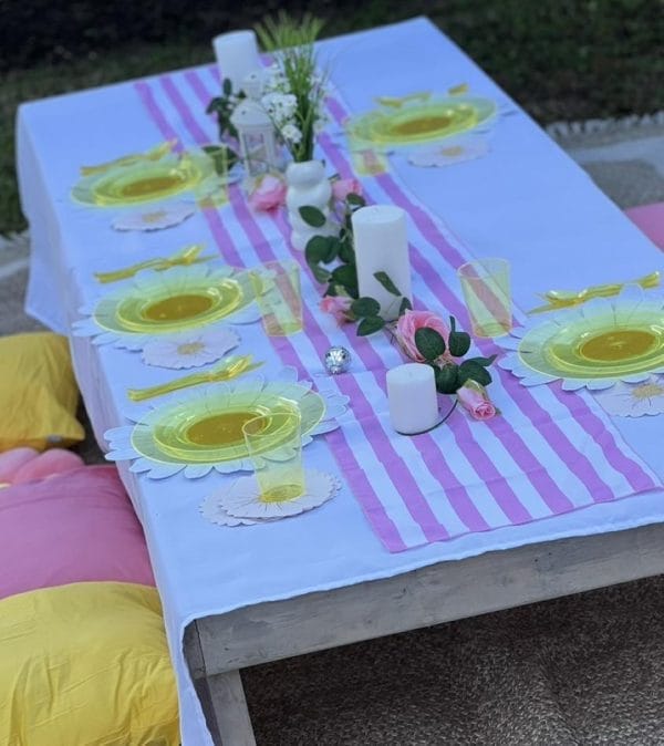 A pink and yellow table setting for a Lakeland party.