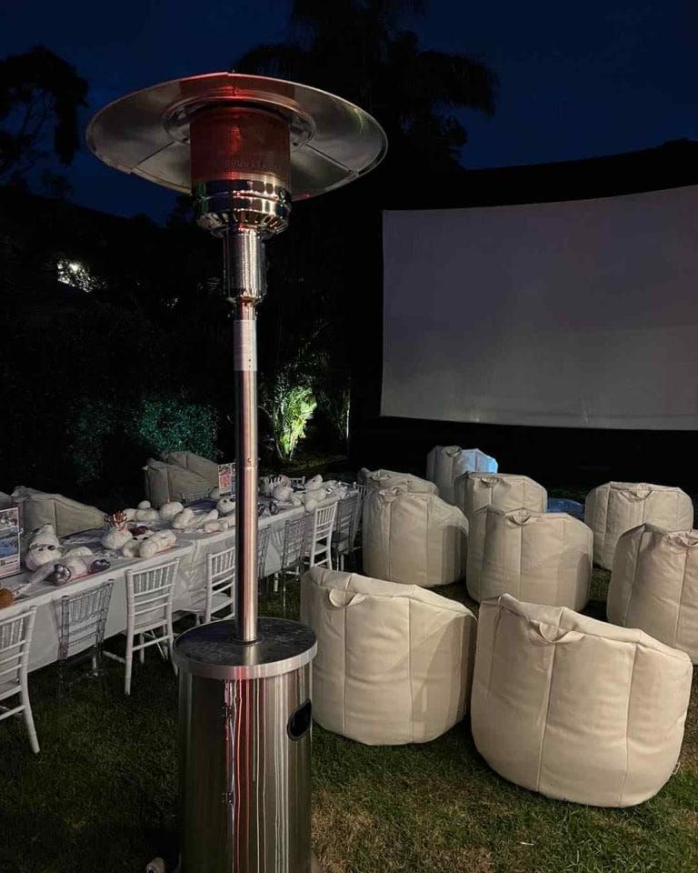 A large outdoor area with a movie screen and a fire pit, perfect for hosting a party in the Lakeland.