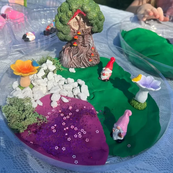 A table full of gnome sand art at a party.