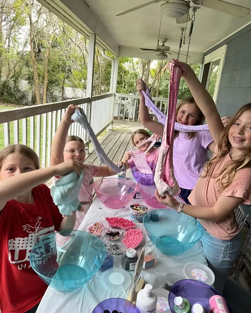 Children enjoying a slime-making activity on a Barbie Themed Party on a porch.